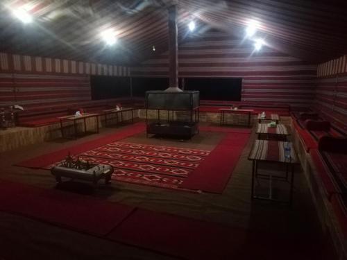 a large room with a stage and a large screen at Wadi rum Local guide camp in Wadi Rum