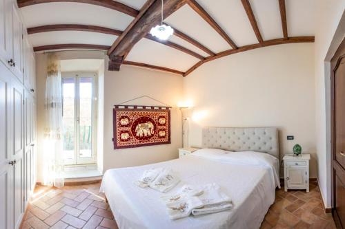 a bedroom with two beds and a large window at La Casa di Lalla in Sutri