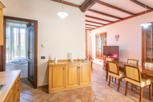 a kitchen with a wooden table and a dining room at La Casa di Lalla in Sutri
