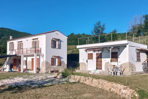 une grande maison blanche sur une colline avec une cour dans l'établissement Minicasa nella fattoria, à Atessa