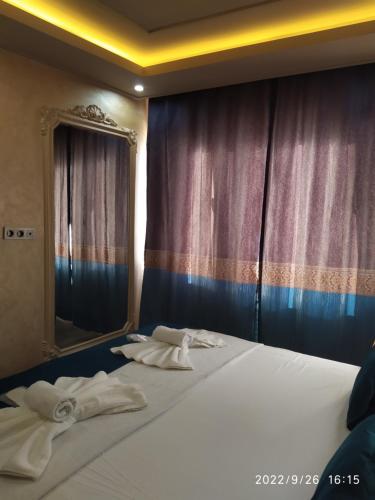 a bed with towels on it with a mirror at THE MOSS Hotel in Istanbul