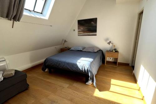 a small bedroom with a bed and a window at La Cabarette in Arry