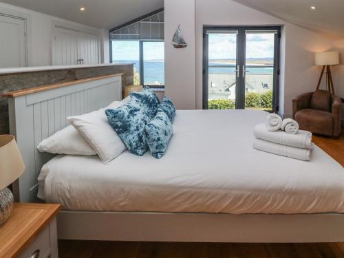 a bedroom with a bed with a view of the ocean at Seafield in Carbis Bay