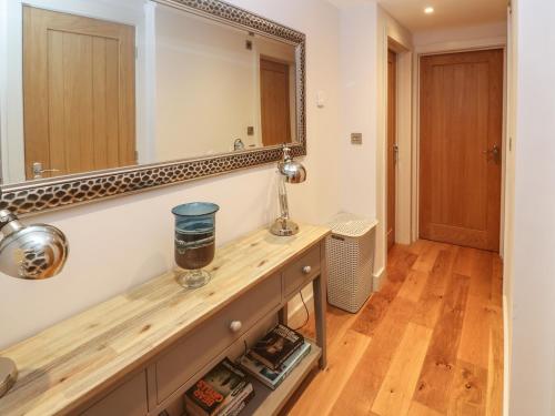 a bathroom with a vanity with a large mirror at Seafield in Carbis Bay