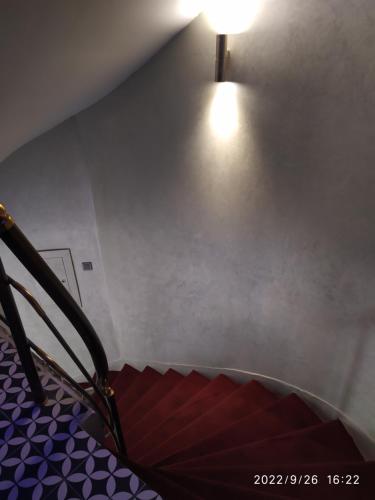 a stairway with a light on the wall and a stair case at THE MOSS Hotel in Istanbul