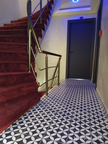 a staircase with a black door and black and white floor at THE MOSS Hotel in Istanbul