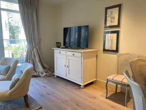 a living room with a tv on top of a cabinet at Walcot Yard with parking, Bath Keys in Bath