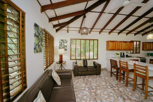 a living room with a couch and a table at Dreamy Contentment in Matapalo