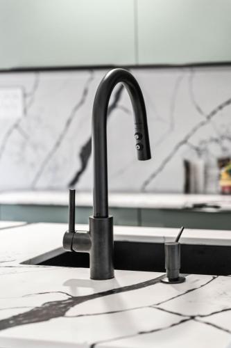 a kitchen sink with a faucet on a counter at Les Petits Chalets in Val-des-Lacs