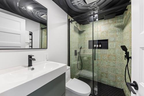 a bathroom with a sink and a shower at Les Petits Chalets in Val-des-Lacs