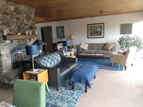 a living room with a couch and a fireplace at 13 Hills Bed & Breakfast in South Acworth