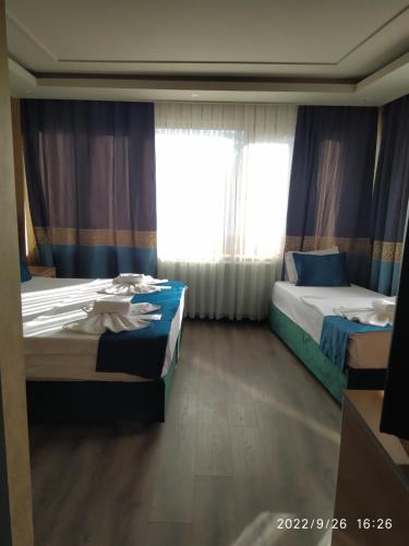 a bedroom with two beds and a window at THE MOSS Hotel in Istanbul
