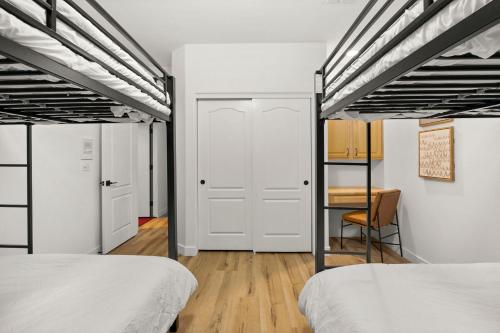 a bedroom with two beds and a desk at Pool Table, Putting Green Luxury Oasis in Mesa in Mesa