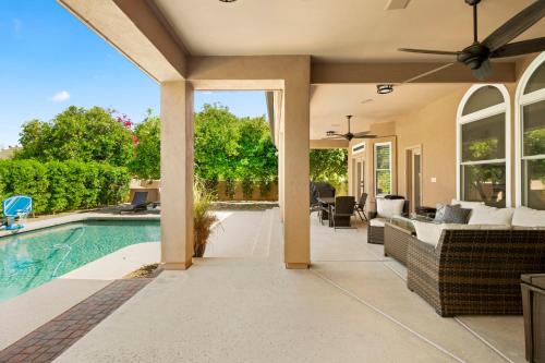 an outdoor living room with a pool and a house at Pool Table, Putting Green Luxury Oasis in Mesa in Mesa