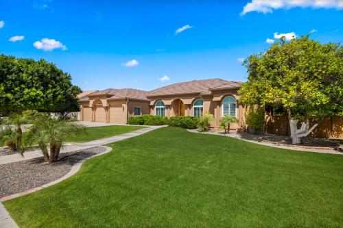 a house with a green lawn at Pool Table, Putting Green Luxury Oasis in Mesa in Mesa