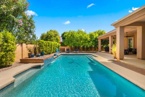 a swimming pool in the backyard of a house at Pool Table, Putting Green Luxury Oasis in Mesa in Mesa
