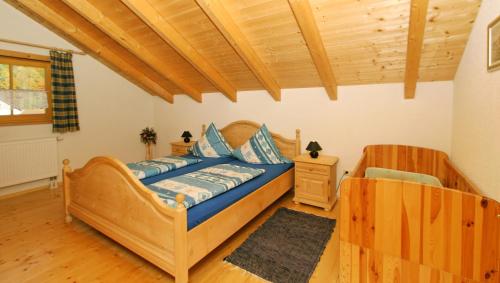 a bedroom with a bed and a wooden ceiling at Ferienhaus Schachtenbach in Bayerisch Eisenstein
