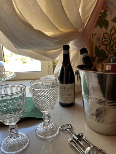 a counter with two bottles of wine and two glasses at Casa Fara in Fara San Martino