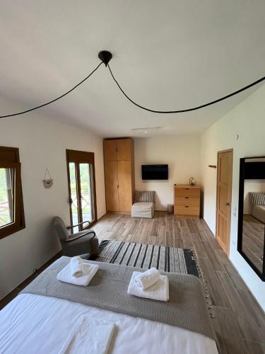 a bedroom with a bed with two towels on it at Paralia Homes peaceful 2 bedroom, unit # 2 in Kriopigi