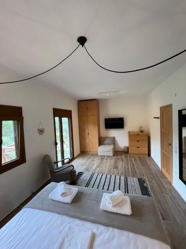 a bedroom with a bed with two towels on it at Paralia Homes peaceful 2 bedroom, unit # 2 in Kriopigi