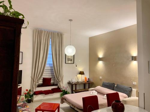 a living room with a bed and a couch at Chroma Apt Farinone 28 in Rome