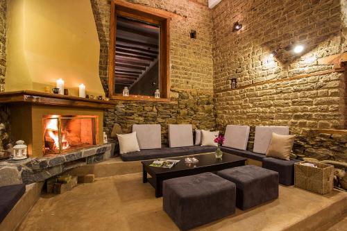 a living room with a couch and a fireplace at Garmen Hills Guest Houses in Garmen