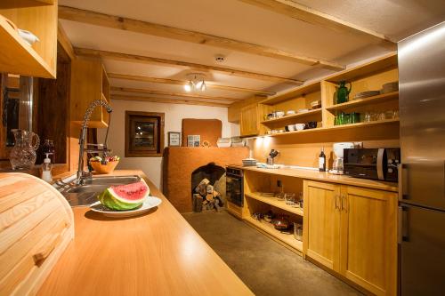 a kitchen with a counter with a plate of watermelon on it at Garmen Hills Guest Houses in Garmen
