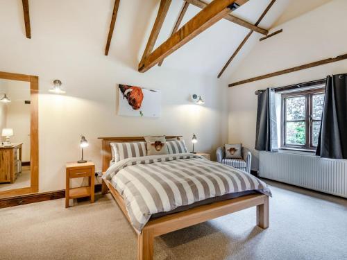 a bedroom with a bed and a window at High House Barn - Uk36929 in Foulsham