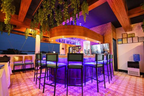 a bar with purple bar stools in a restaurant at Kingswick Residences & Lodge in Dumaguete