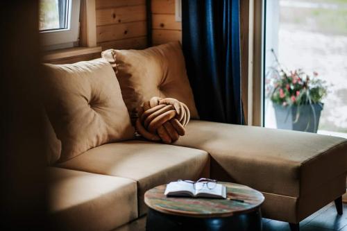 a living room with a couch and a table at Lawendowy Zakręt in Ustrzyki Dolne