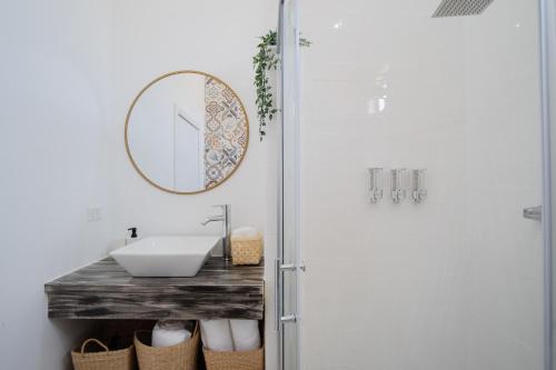 a bathroom with a sink and a mirror at Finca San Sebastian in Valle de Guadalupe