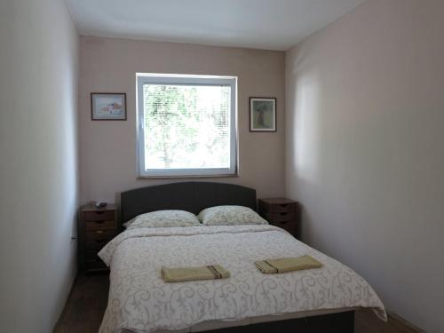 a bedroom with a bed with two towels on it at Modern&Cozy Bosnian house with GARDEN+FREE parking in Sarajevo