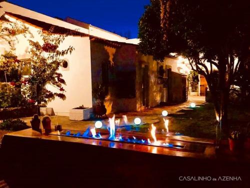 a yard with a lit up fountain in front of a house at Casalinho da Azenha - Charm House in Sintra