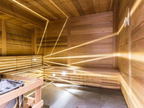 a sauna with wooden walls and a wooden floor at Appartement style chalet 5* vue Mont-Blanc - Arc 1950 in Arc 1950