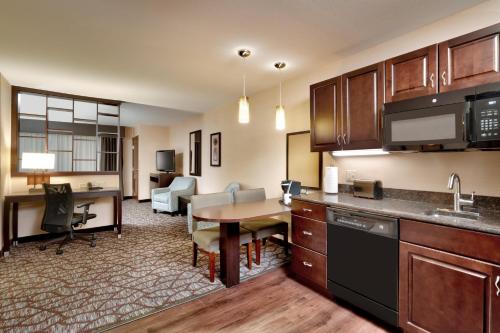 a kitchen and living room with a table and a dining room at Holiday Inn Express Hotel & Suites Butte by IHG in Butte