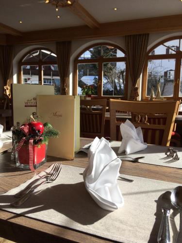 a dining room table with silverware on a table at Hotel Metzgerwirt in Kirchberg in Tirol