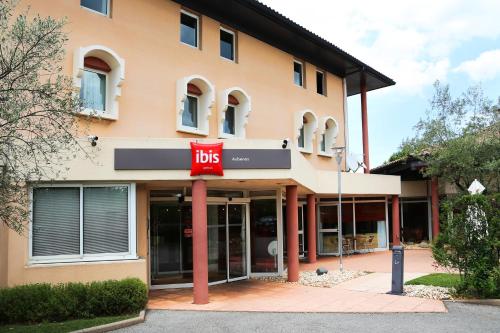 a building with a bus sign in front of it at ibis Aubenas in Aubenas