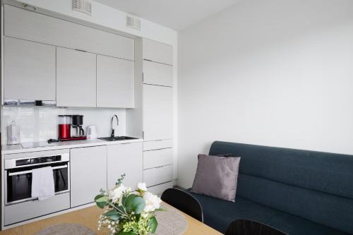 a living room with a couch and a table at 7.kerroksen huoneisto, Wifi + 24/7 check in in Turku