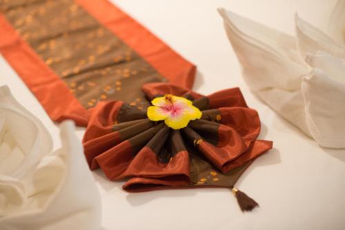 a close up of a flower on a table at Srichada Hotel Khaolak - SHA Extra Plus in Khao Lak