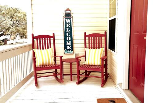 two chairs and a table on a porch at Walk to the Beach-Sleeps 10 and Golfcart in Myrtle Beach