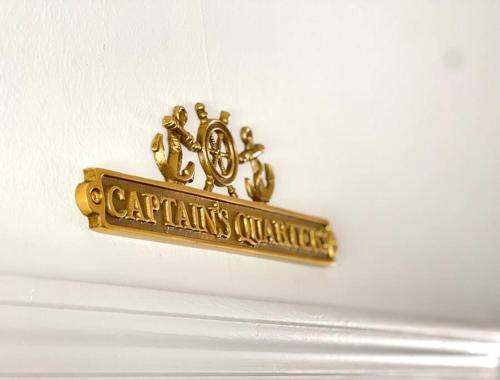 a gold sign hanging on a white wall at Walk to the Beach-Sleeps 10 and Golfcart in Myrtle Beach