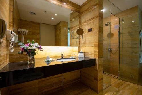 a bathroom with a sink and a shower at Eurobuilding Hotel Boutique Buenos Aires in Buenos Aires