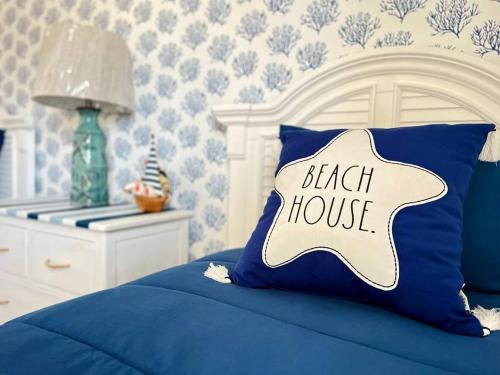 a blue bed with a pillow with the words breach house at Walk to the Beach-Sleeps 10 and Golfcart in Myrtle Beach