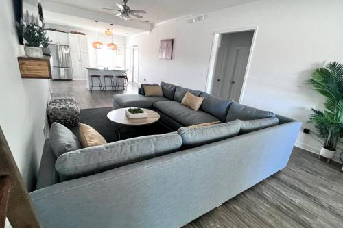 a living room with a blue couch and a table at Walk to the Beach-Sleeps 10 and Golfcart in Myrtle Beach