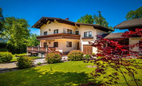 a large house with a yard in front of it at Ferienwohnung Wallmerhof am ländlichen Wimberg in Adnet
