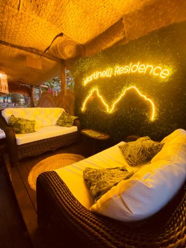 a room with two beds and a sign that readsnatural residence at Martinelli Residence in Fernando de Noronha