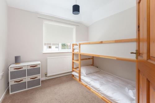 a bedroom with two bunk beds and a window at Charles Alexander Short Stay - Moorway House in Poulton le Fylde