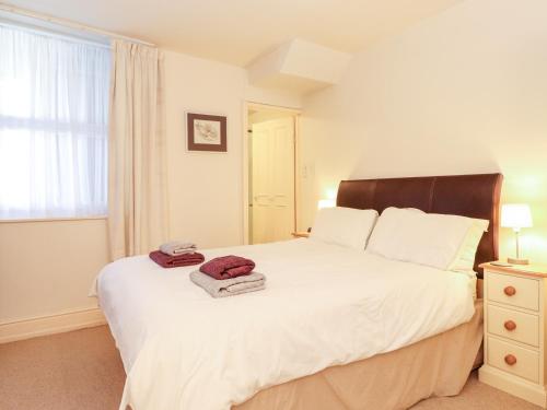 a bedroom with a large white bed and a window at Archers in Keswick