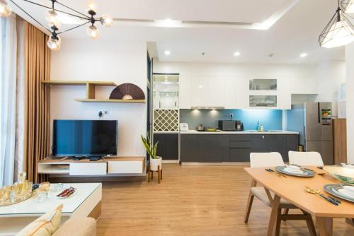 a living room with a kitchen and a dining room at Sunny Vinhome Metropolis Apartment in Hanoi