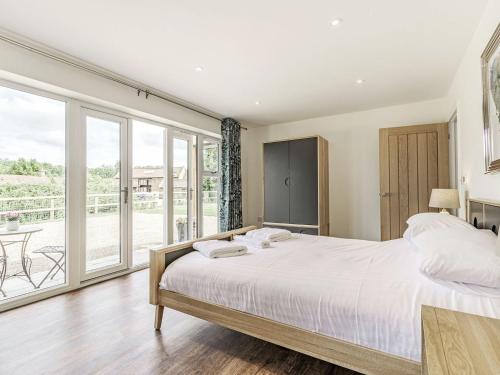 a bedroom with a bed and a large window at Kings Lodge in Neatishead